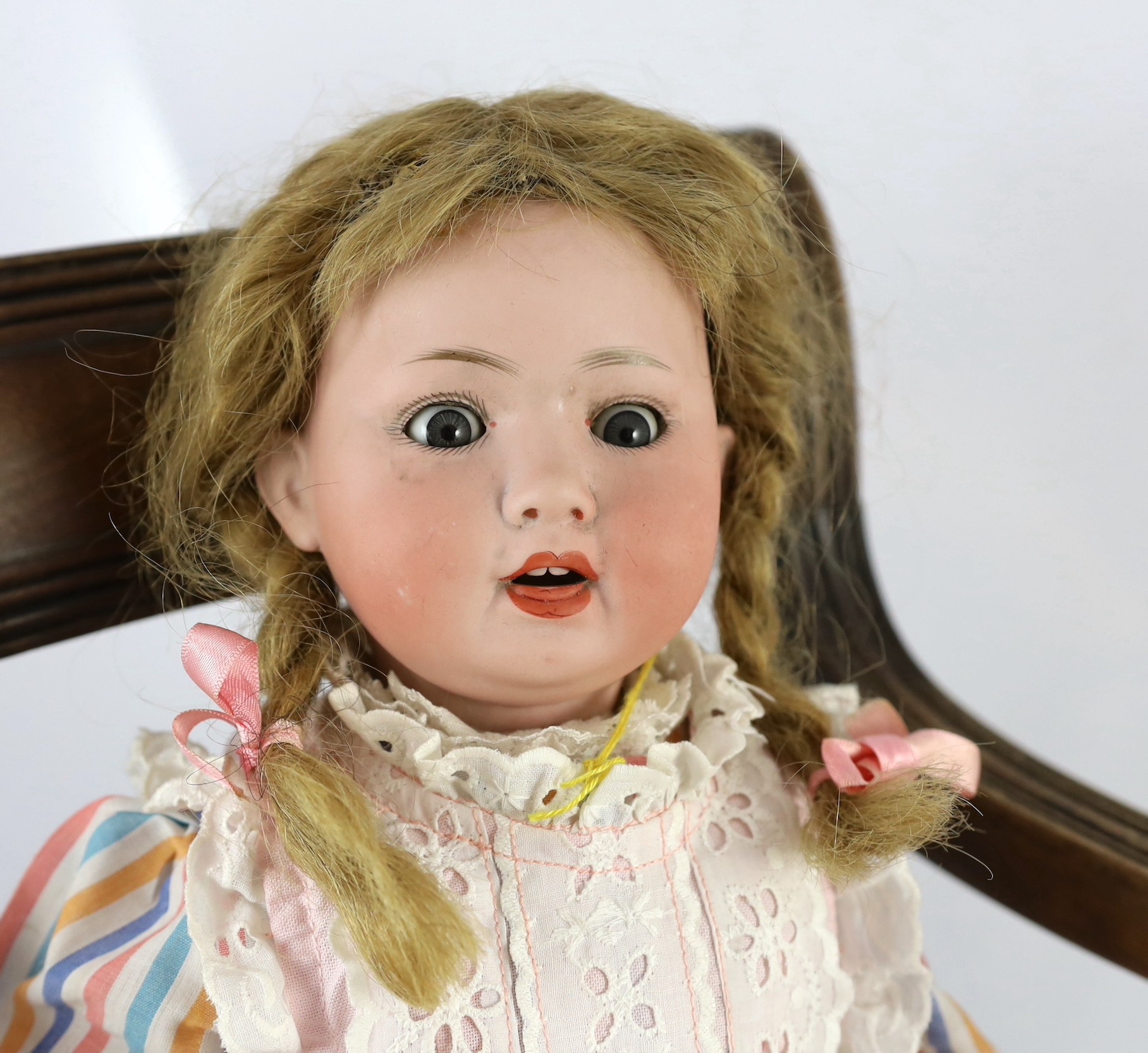 A Porzellanfabrik Mengersgereuth bisque doll, German, circa 1920, 17in. Please note the chair is for display purposes only.
